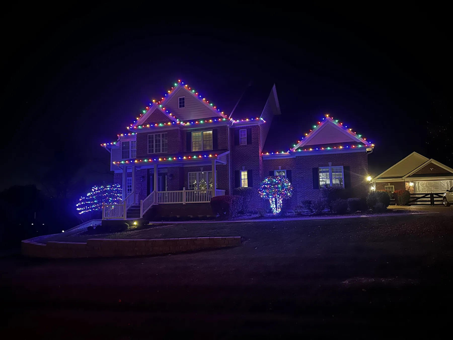 Multicolor roofline with lit bushes, November 2023